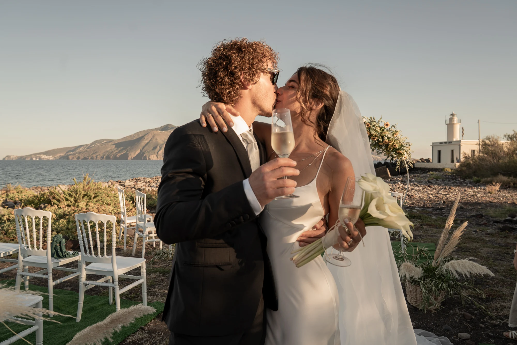 Bacio degli sposi con brindisi e faro alle Isole Eolie